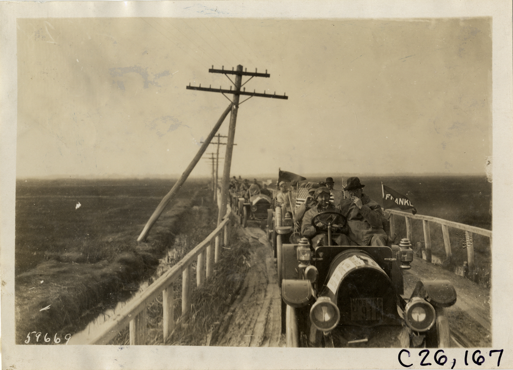 Motorists in automobiles traveling on rural road, 1910 New Jersey Reliability Run