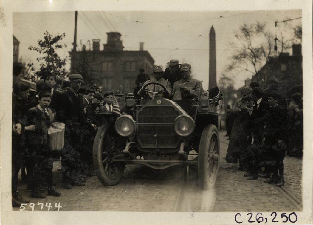 Boys surrounding motorists in automobile, 1910 New Jersey Reliability Run
