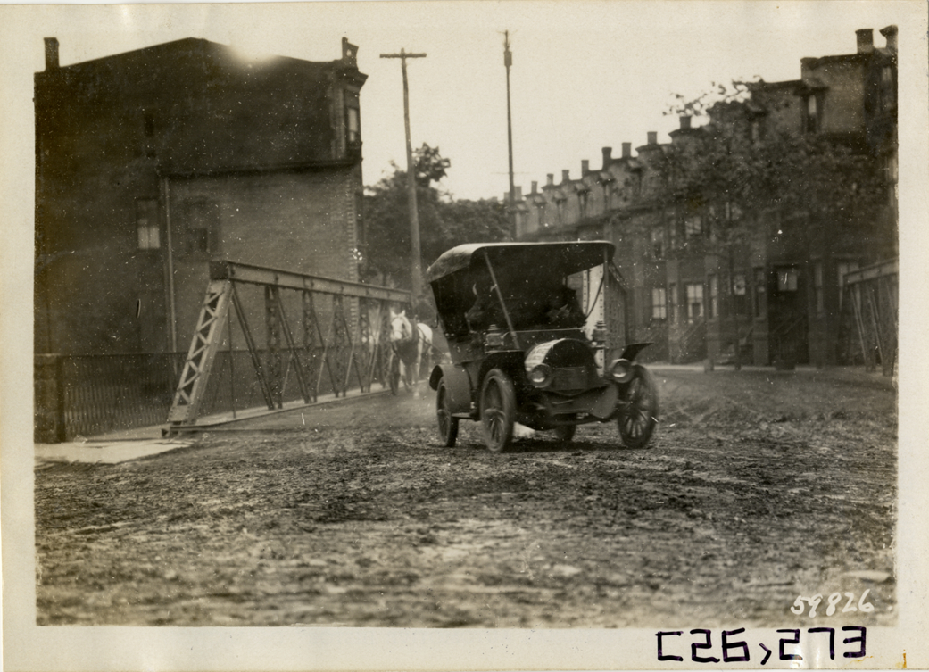Motorists in automobile crossing bridge, 1910 New Jersey Reliability Run