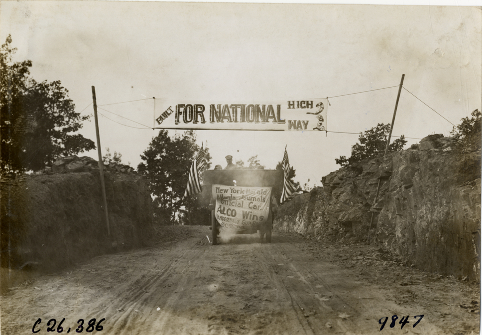 Alco official automobile approaching banner, 1909 New York-Atlanta Good Roads Tour