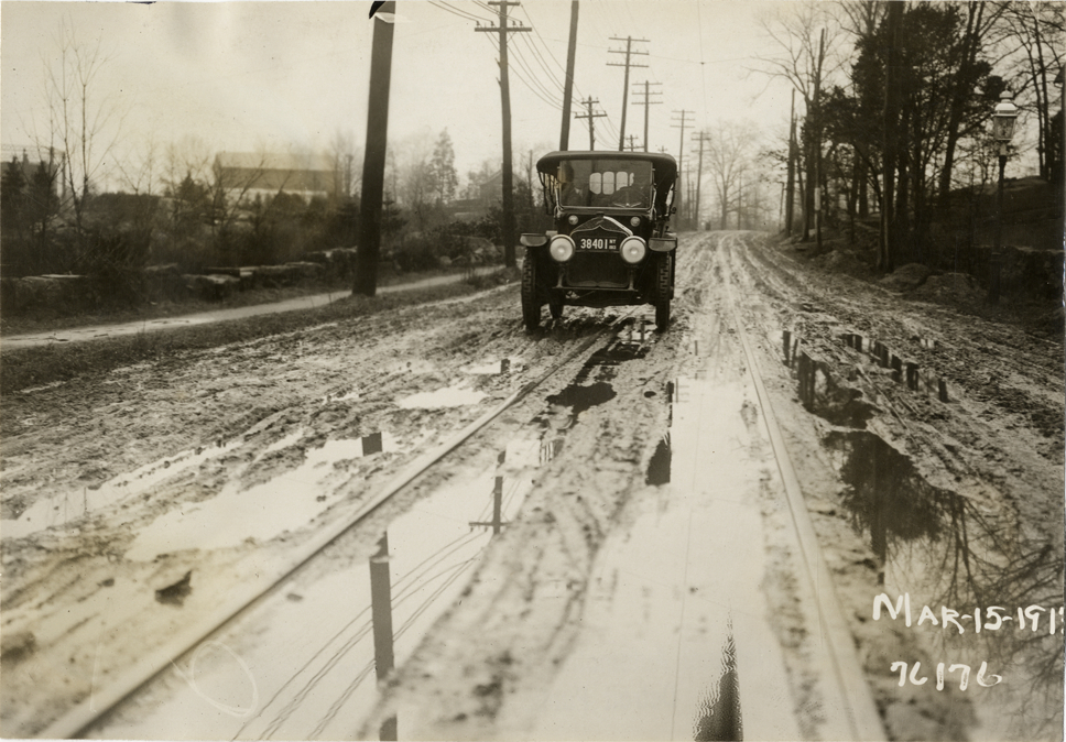 National automobile traveling on muddy road, 1913 Overman tires 10,000 mile demonstration