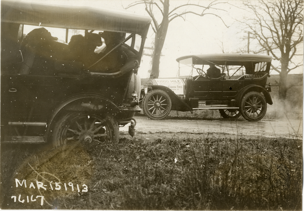 Motorist in National automobile on roadside, 1913 Overman tires 10,000 mile demonstration