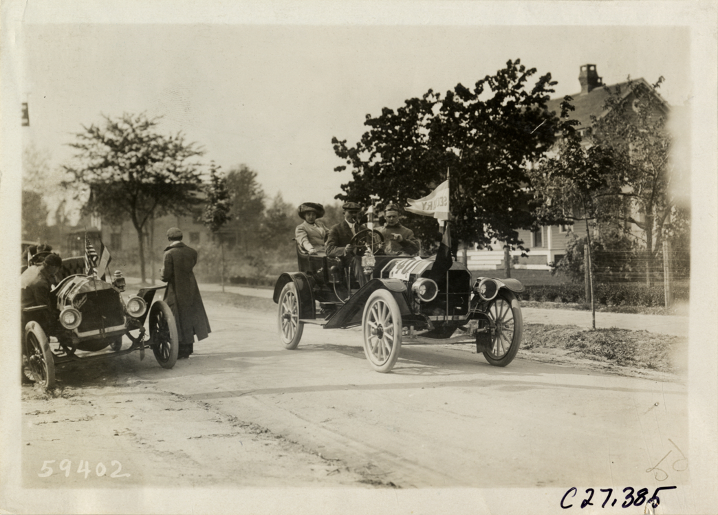 Motorists posing in automobile, 1910 Quaker City Motor Club Roadability Run