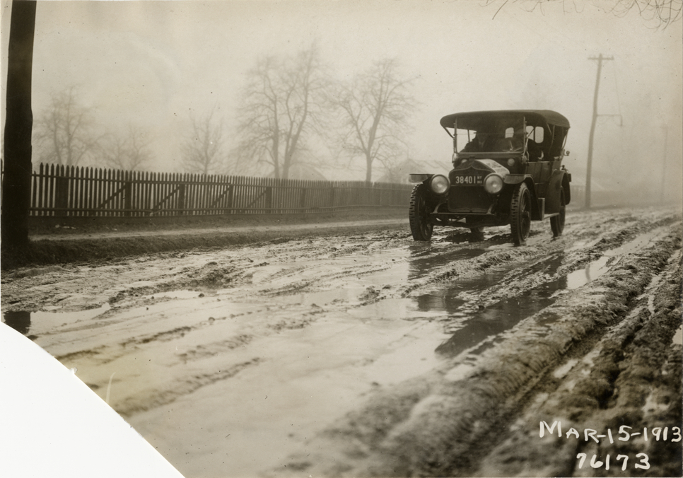 National automobile traveling on muddy road, 1913 Overman tires 10,000 mile demonstration