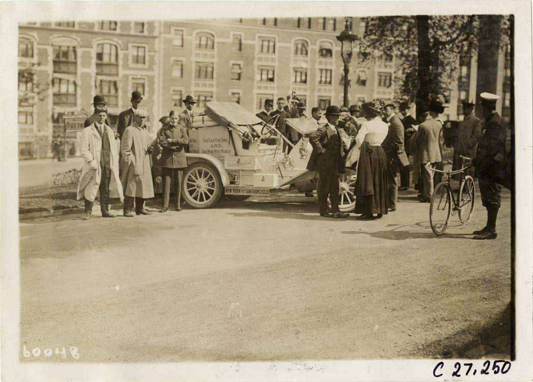 Spectators surrounding Overland automobile, 1910 New York to San Francisco tour
