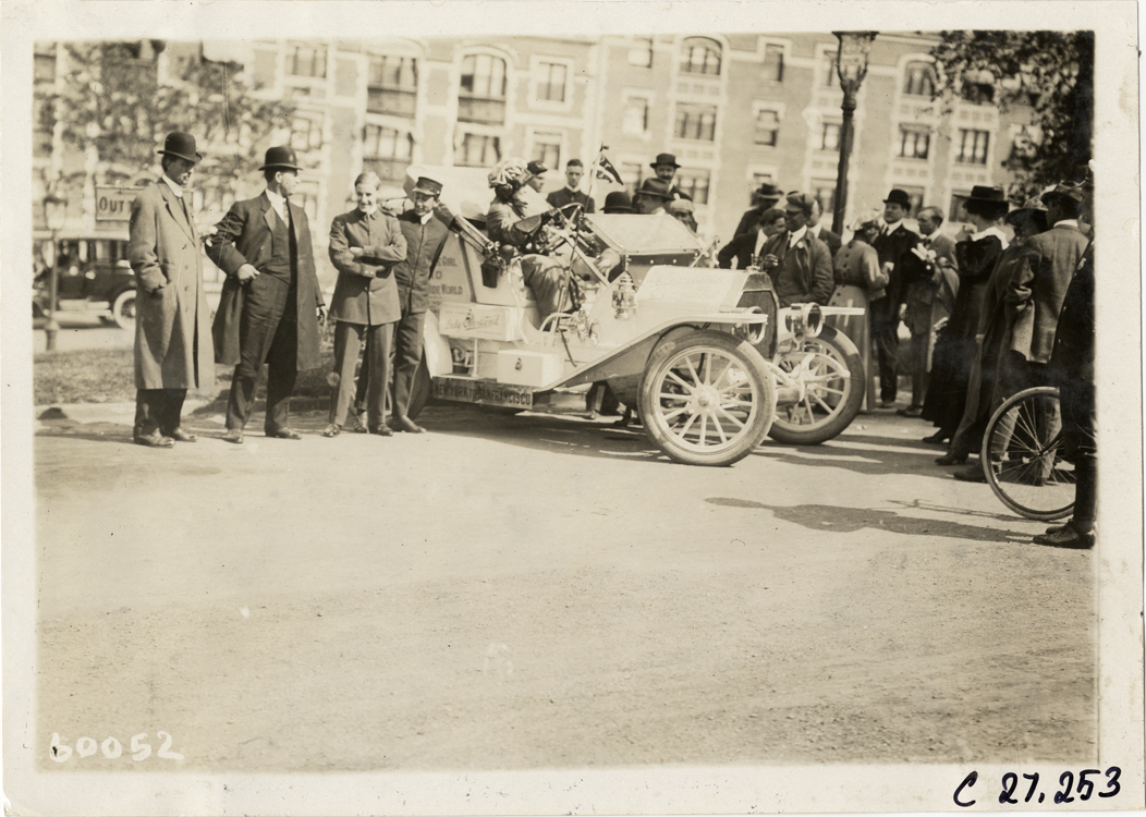 Spectators surrounding Overland automobile, 1910 New York to San Francisco tour