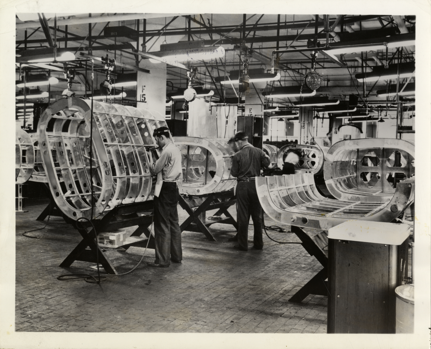 Workers constructing auxiliary fuel tanks, Fisher Body plant