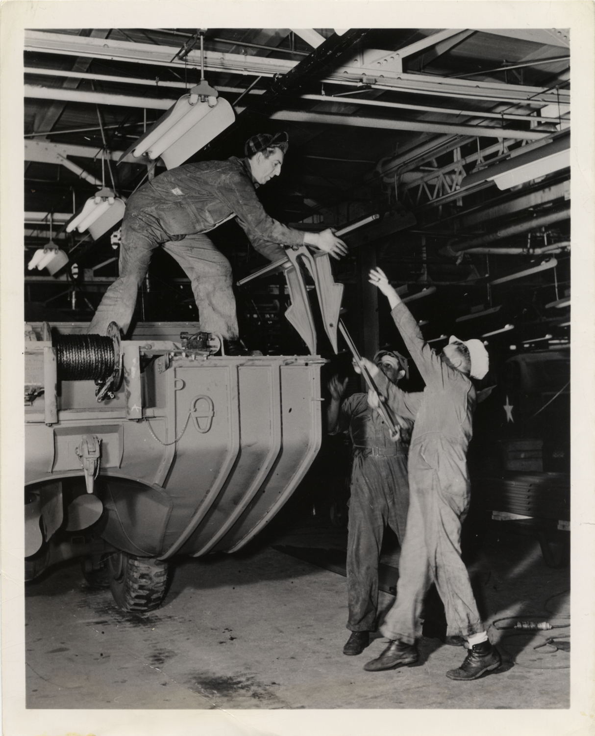 Workers adding anchor to amphibious truck, Chevrolet Assembly Plant, St. Louis, Missouri