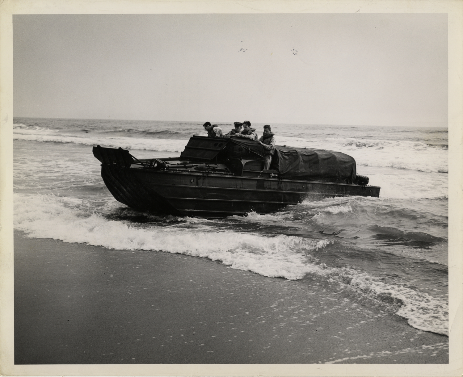 U.S. Coast Guardsmen driving amphibious truck in training maneuver