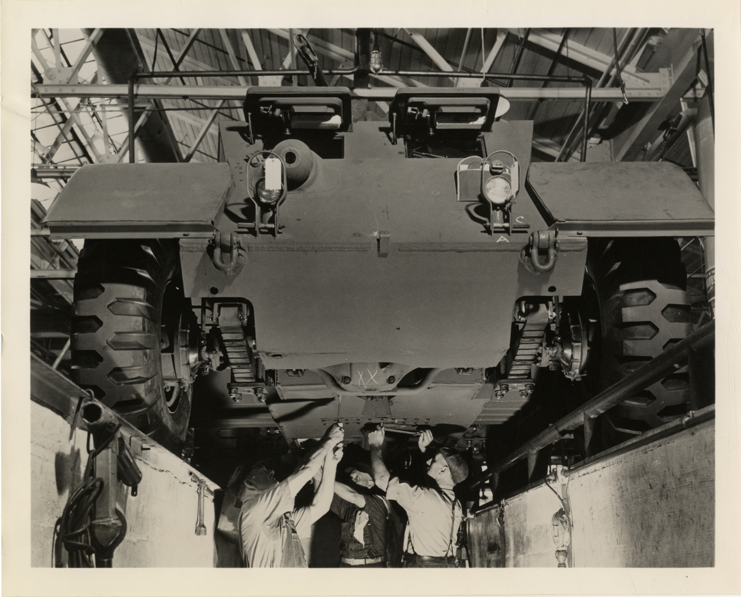 Workers inspecting Chevrolet armored car