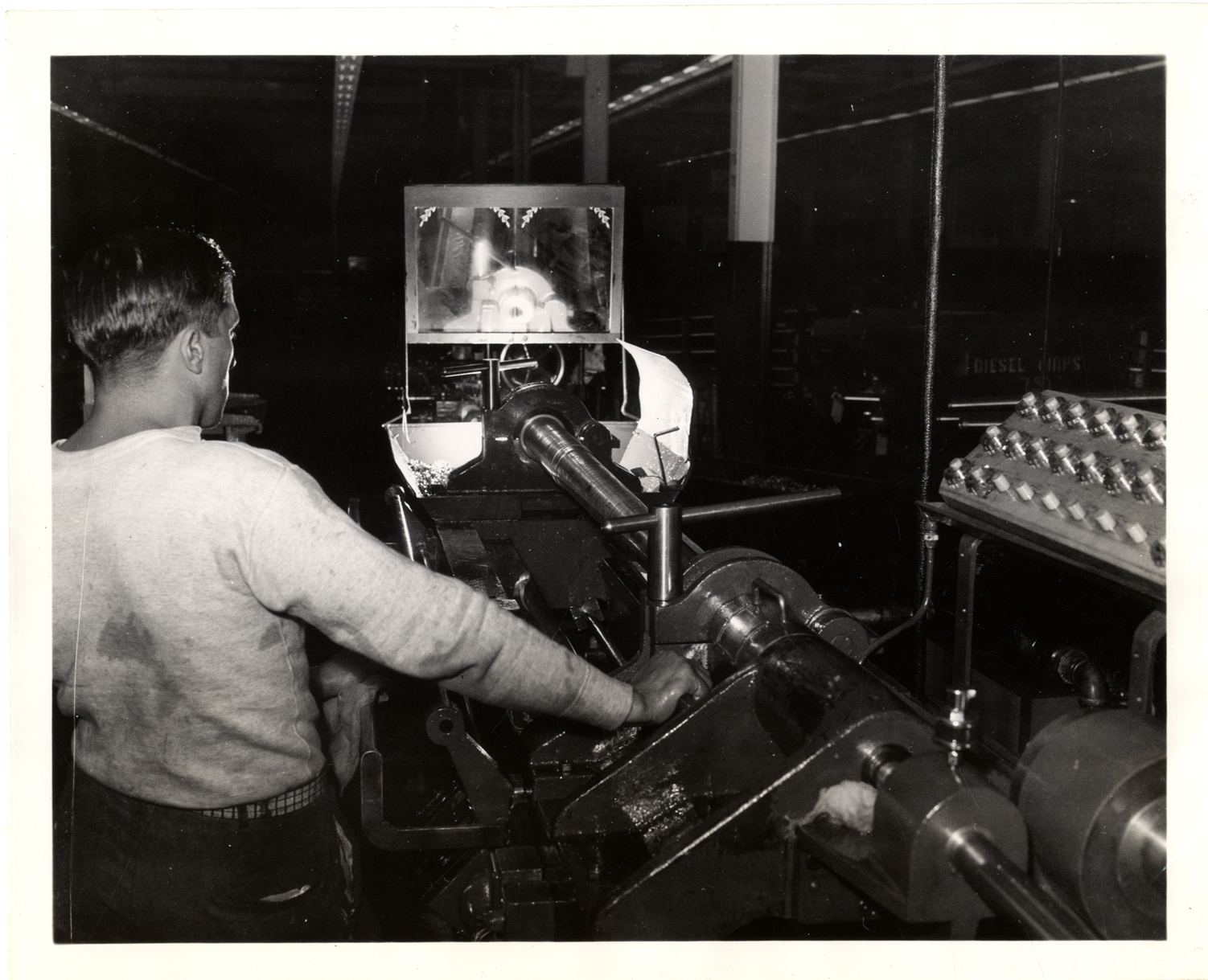 Machinist operating grinding machine