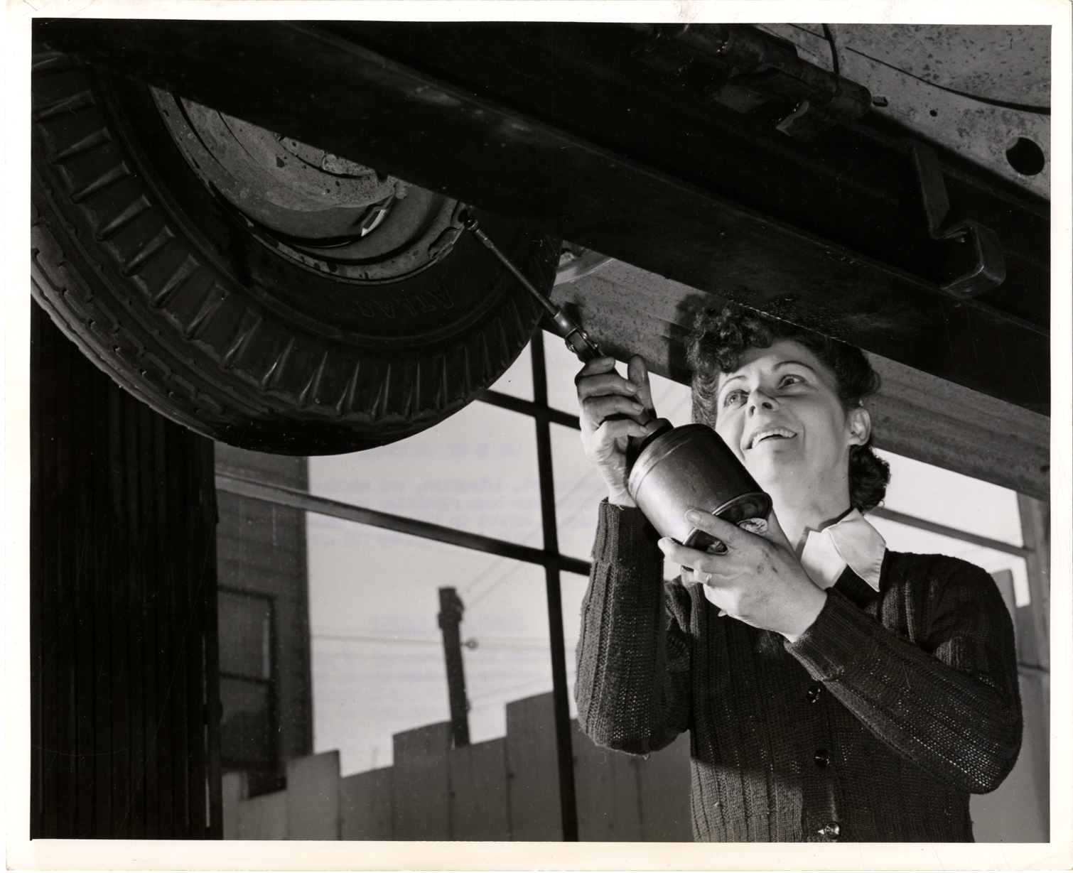 Grace Northrup servicing an automobile