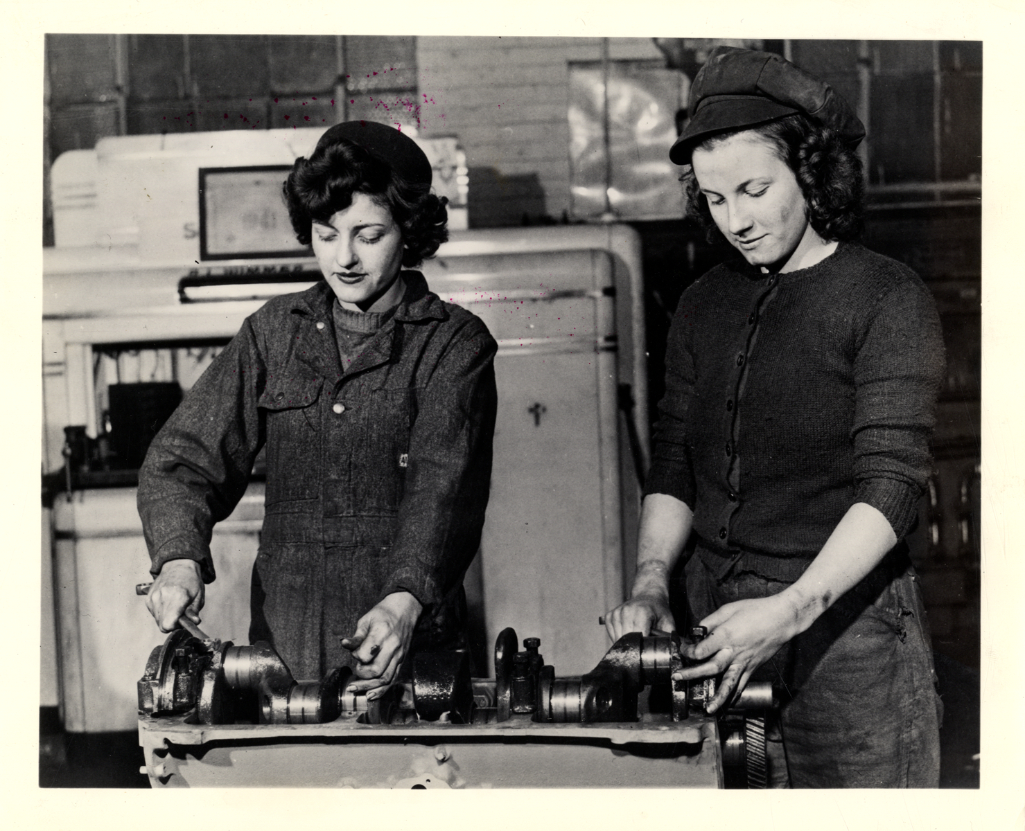 Constance Minter and Olive Graham repairing crankshaft