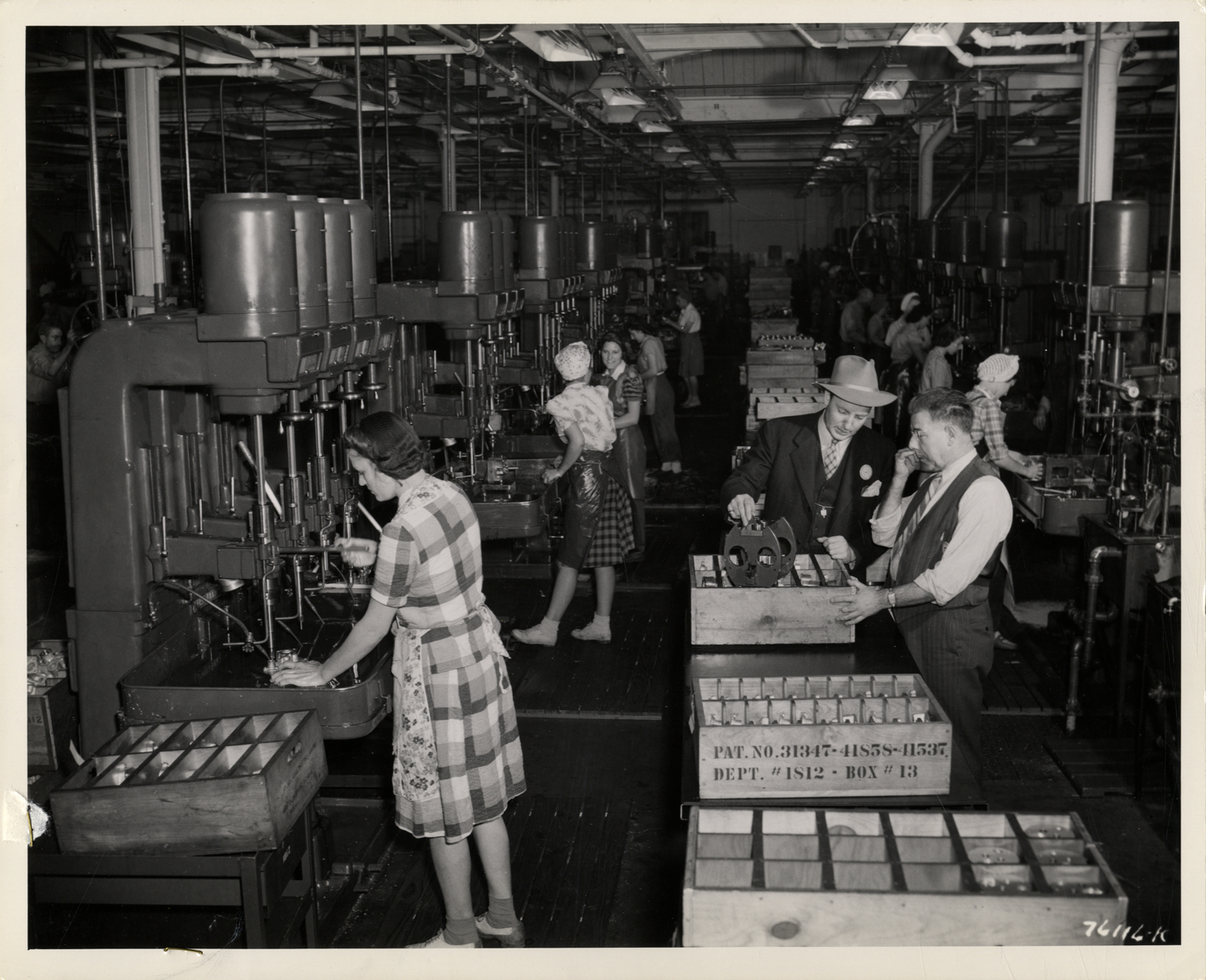 Women workers operating drill presses