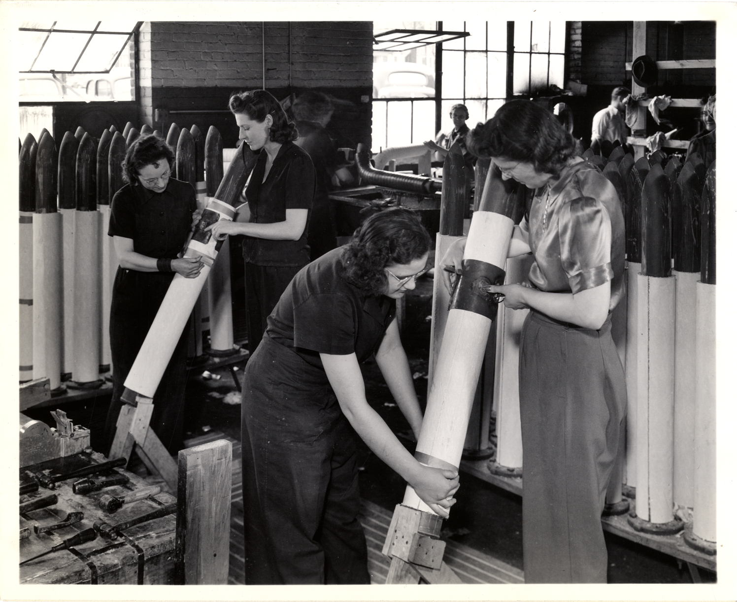 Women workers insulating intake manifolds for tanks, Ray M. Whyte Company