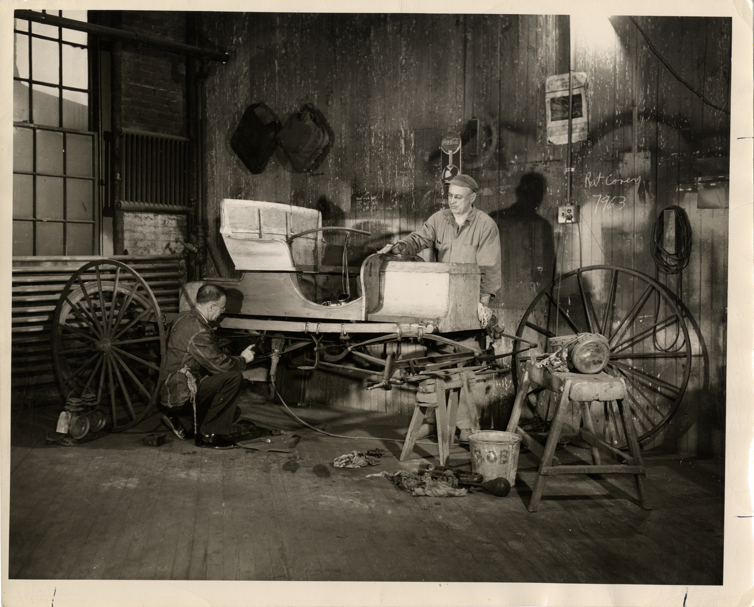 Men restoring a Duryea Buggyaut