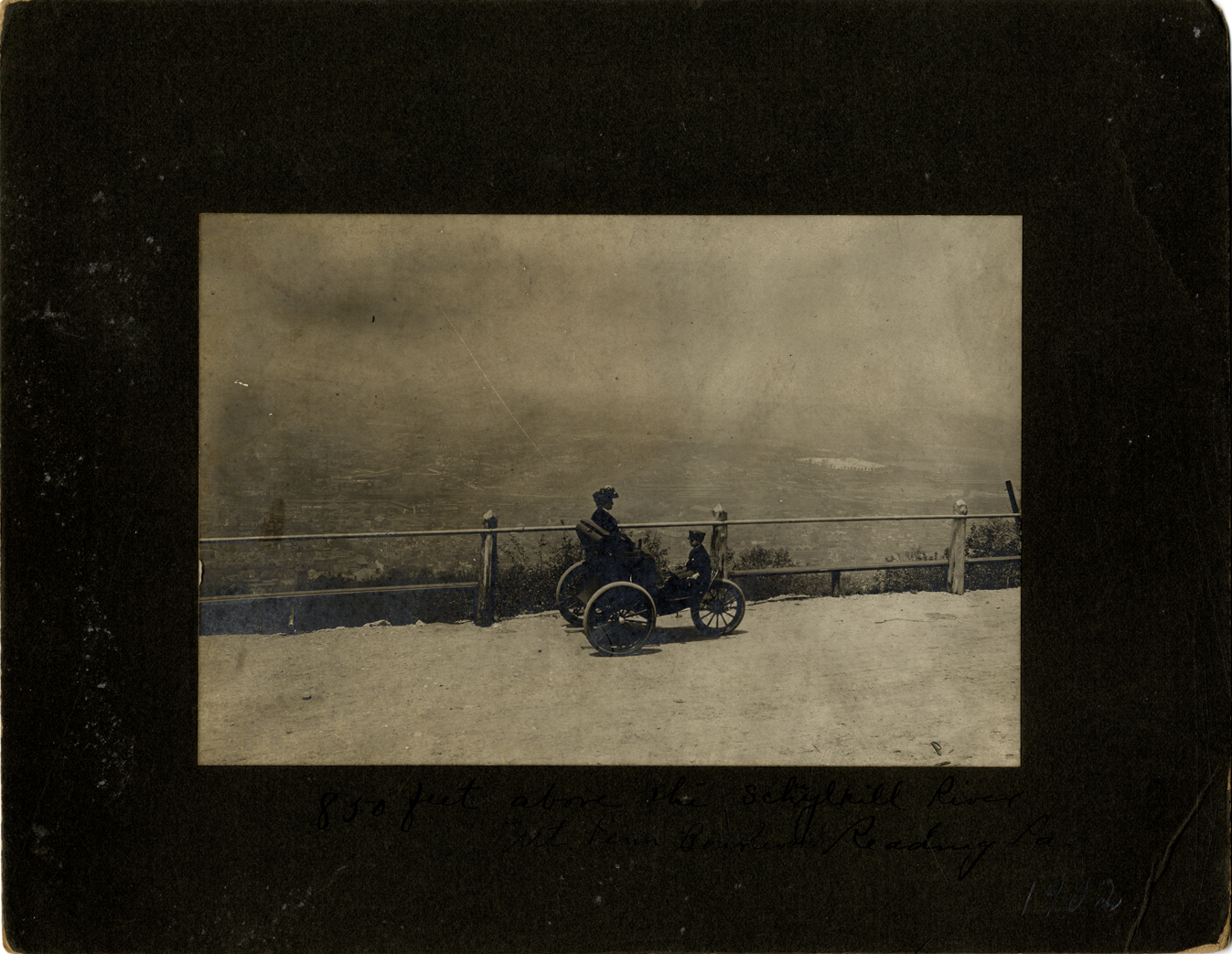 Woman and boy in a 1900 Duryea three-wheeled phaeton
