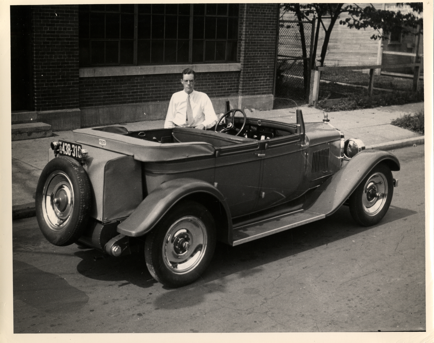 John M. Booth posing with Da Vinci automobile