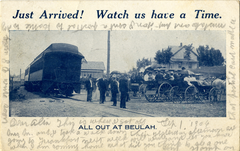 Men and women standing next to train, Beulah, Michigan