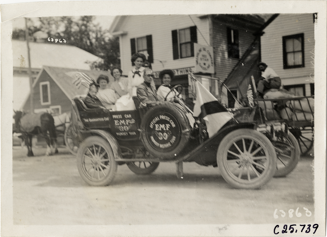 Women and man posing in E-M-F press automobile, 1910 Munsey Historic Tour