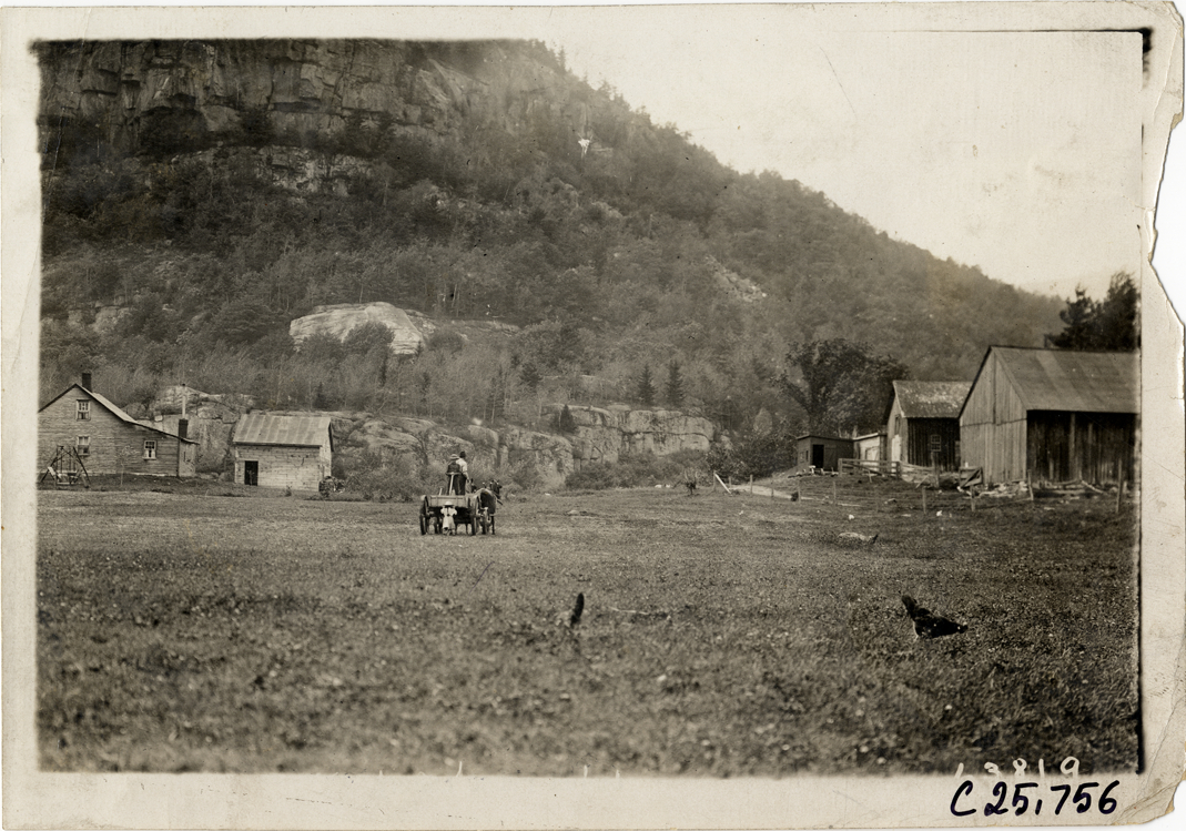 Horse-drawn wagon on farm at foot of mountains, 1910 Munsey Historic Tour