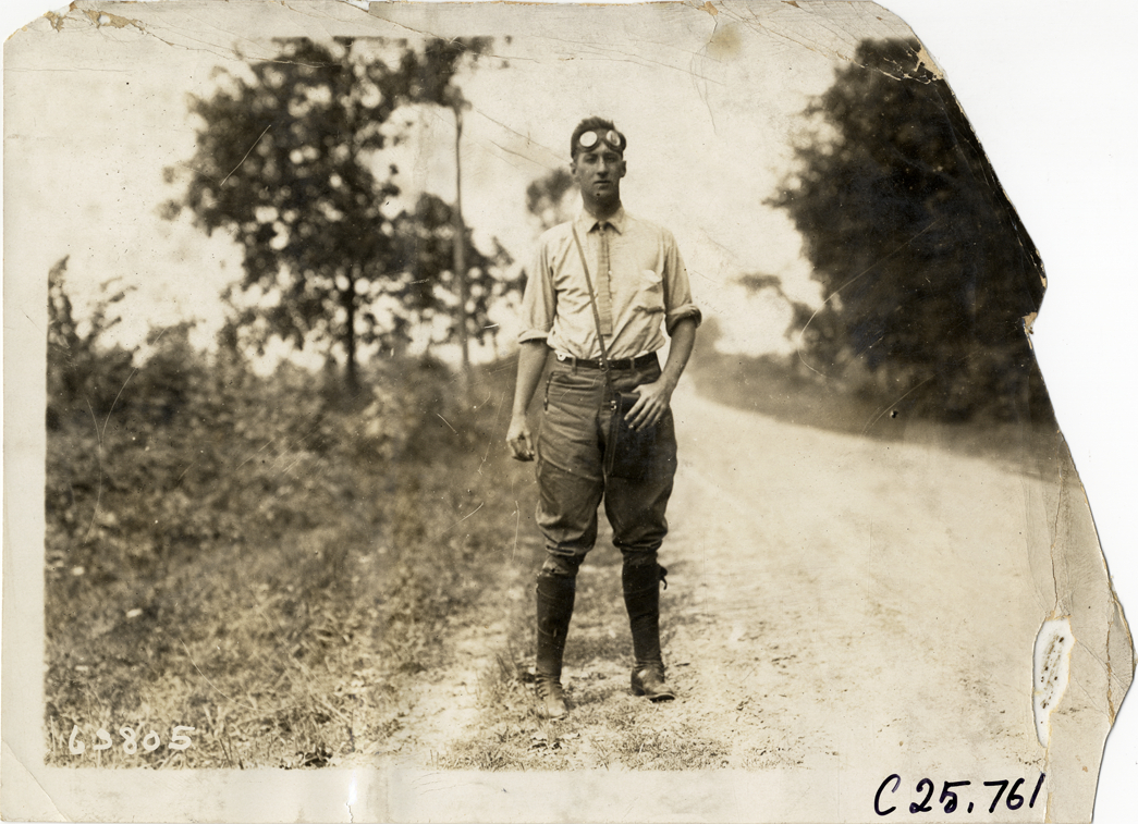 Motorist standing on rural road, 1910 Munsey Historic Tour