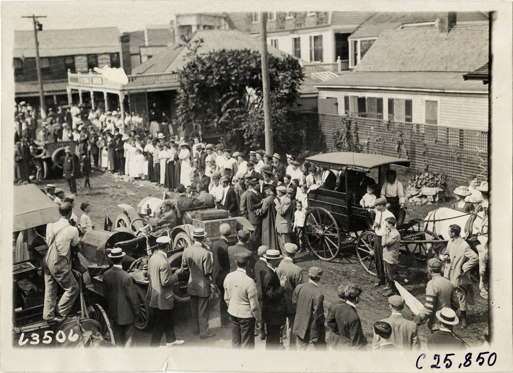 Crowd surrounding automobiles in street at North Conway, New Hampshire, 1910 Munsey Historic Tour
