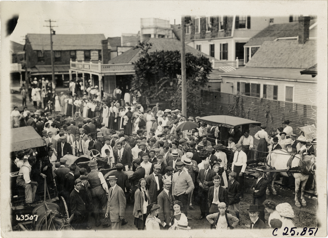Crowd surrounding automobiles in street at North Conway, New Hampshire, 1910 Munsey Historic Tour