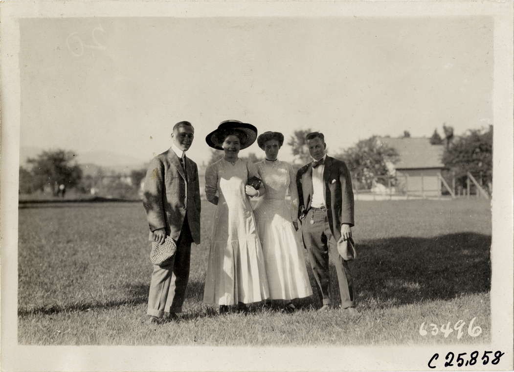 Two couples posing in field, 1910 Munsey Historic Tour