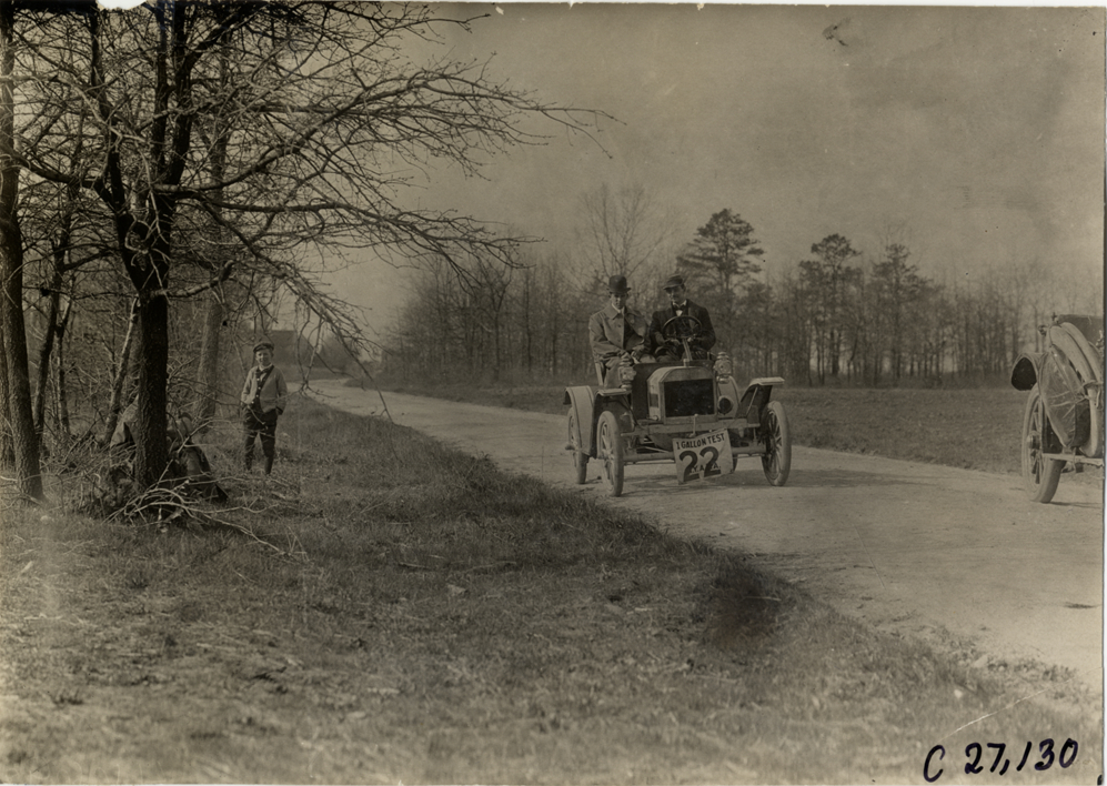 Motorists in automobile traveling on rural road, 1909 New York Economy Contest
