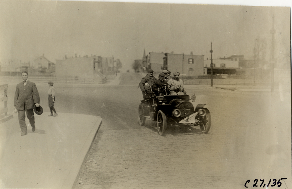 Motorists in Franklin automobile turning corner, 1909 New York Economy Contest