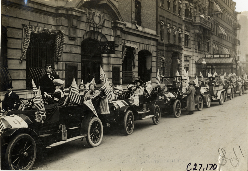 Children and motorists in automobiles lined up in street, 1909 New York Orphans Day outing