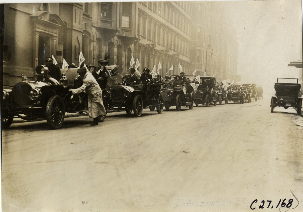 Children and motorists in automobiles lined up in street, 1909 New York Orphans Day outing
