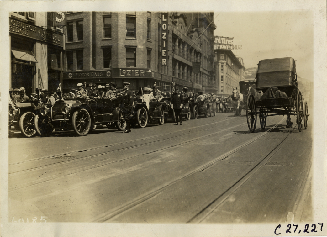 Children and motorists in automobiles lined up in street, 1910 New York Orphans Day outing