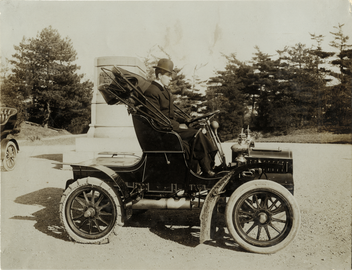 Driver posing in 1905 Cadillac Model F automobile