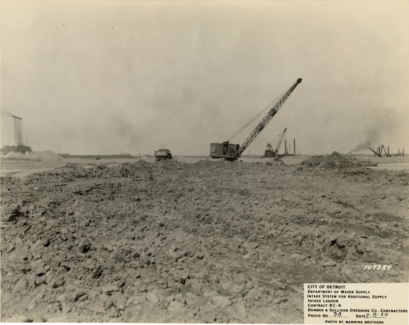 Cranes and truck in fill area, Detroit water supply system