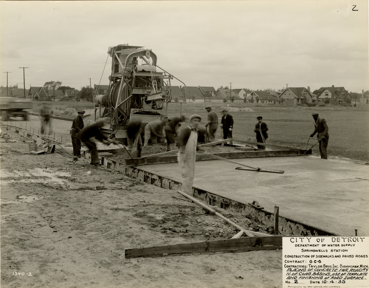 Workers pouring concrete for road, Springwells Station, Detroit water supply system