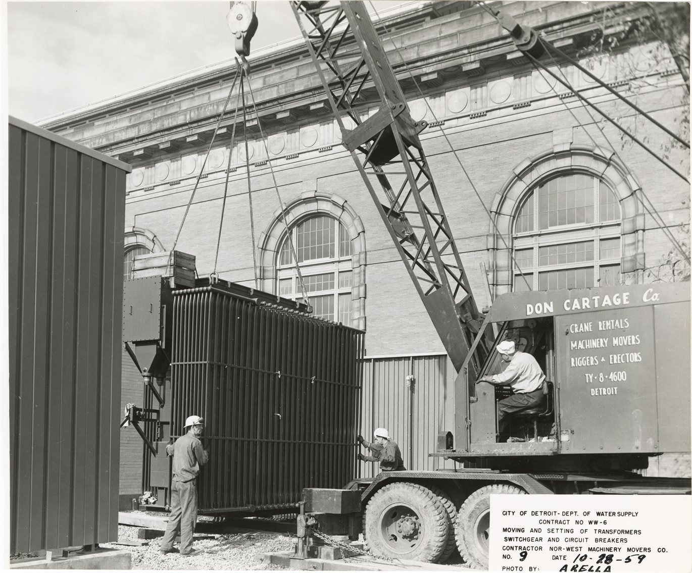 Workers lifting transformer into bay with crane, Waterworks Park, Detroit water supply system