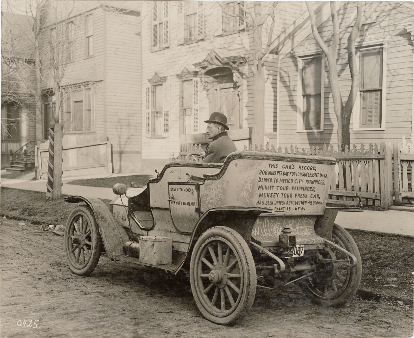 Motorist posing in 1909 Chalmers-Detroit 30 automobile