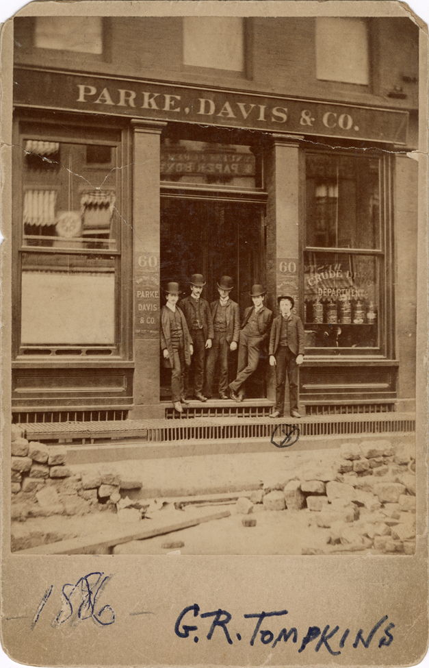 G.R. Tompkins and men posing in front of Parke, Davis & Company office, New York, New York