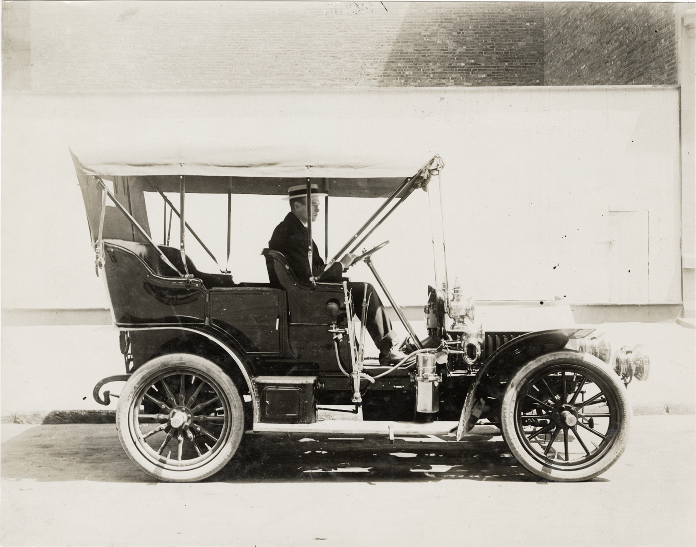 Motorist posing in 1906 Locomobile automobile