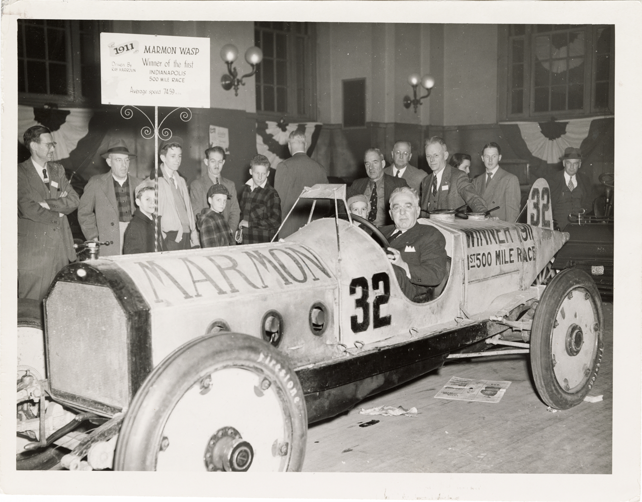 Harry H. Cobe posing in 1911 Marmon Wasp racecar
