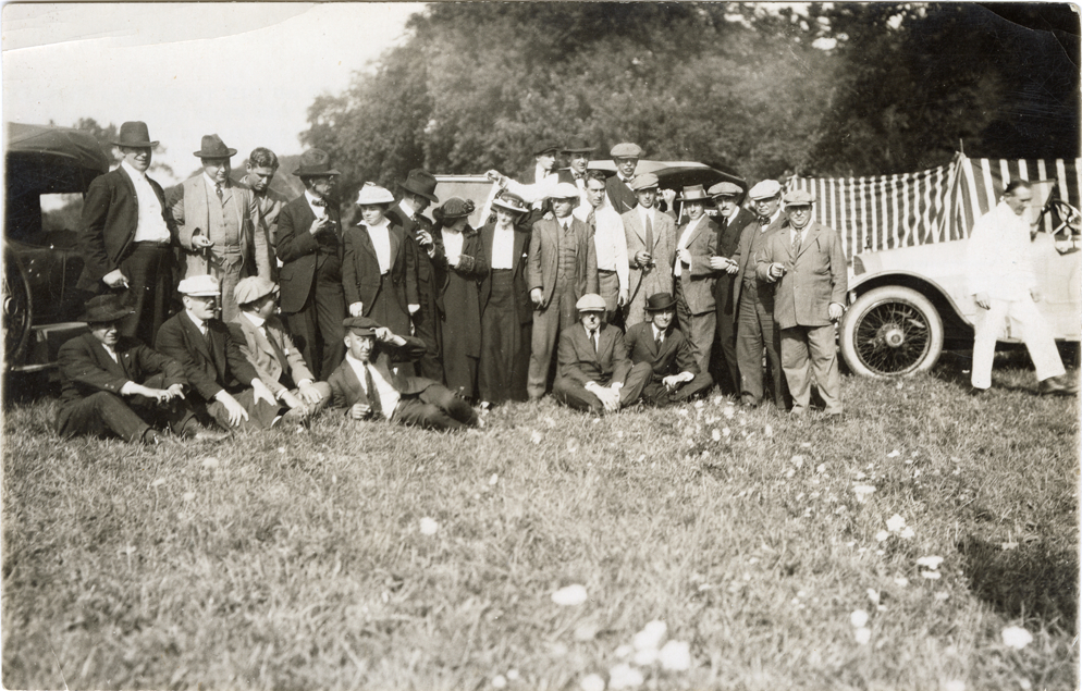 Tourists posing with 1916 Owen-Magnetic automobiles