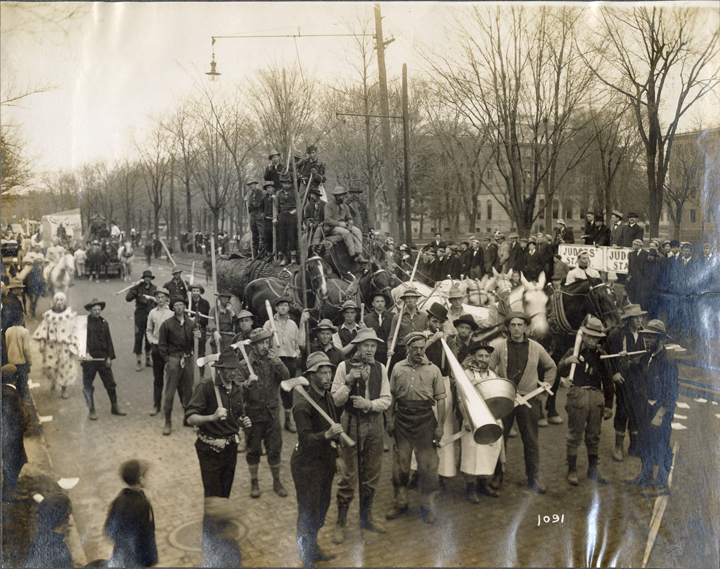 Students costumed as lumberjacks in parade, University of Michigan Triennial County Fair