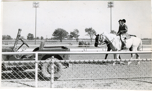 Two stewards riding horses, Michigan Racing Association racetrack