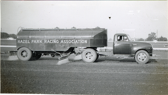 Sprinkler truck on racetrack, Hazel Park Raceway