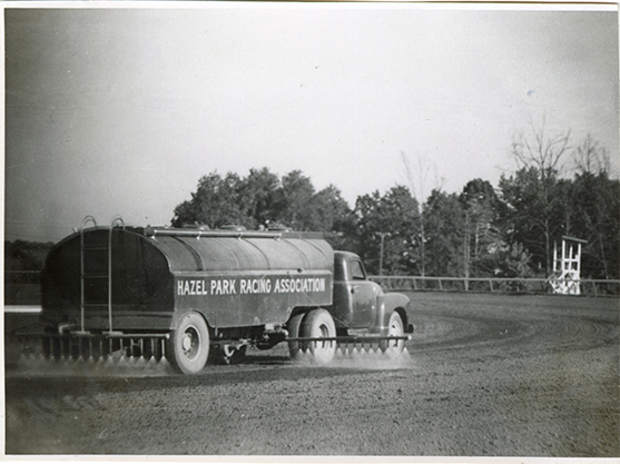 Sprinkler truck on racetrack, Hazel Park Raceway