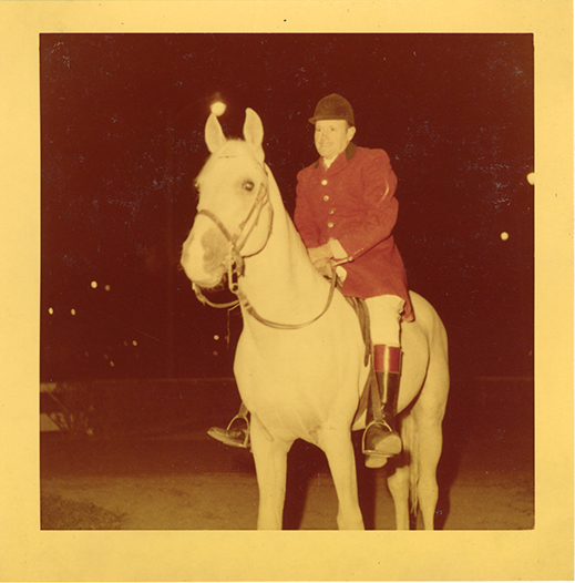 Steward James E. Stolte posing on horse "Nar," Michigan Racing Association racetrack