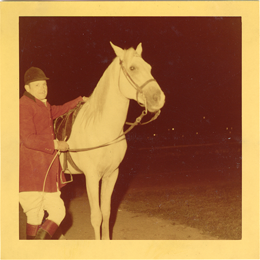Steward James E. Stolte posing with horse "Nar," Michigan Racing Association racetrack