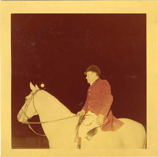 Steward James E. Stolte posing on horse "Nar," Michigan Racing Association racetrack
